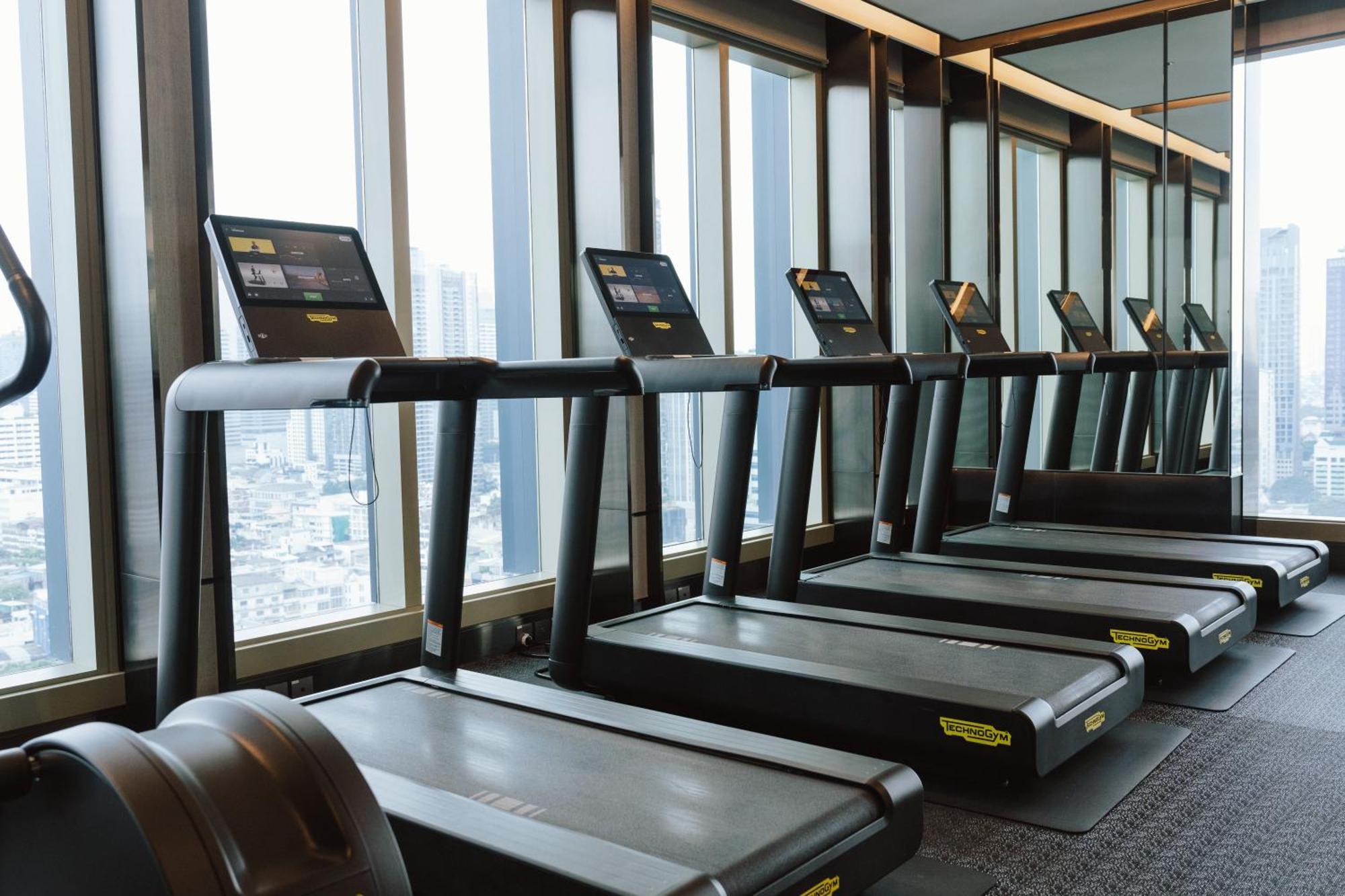 Grande Centre Point Surawong Bangkok Hotel Exterior photo A row of treadmills